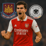 Martin Zubimendi melakukan selebrasi gol bersama Arsenal dengan jersey merah-putih di Emirates Stadium, latar belakang menampilkan logo West Ham United dan timnas Jerman.
